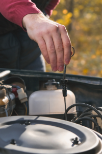 Oil check and maintenance process showing the oil level and warning light on the car dashboard.
